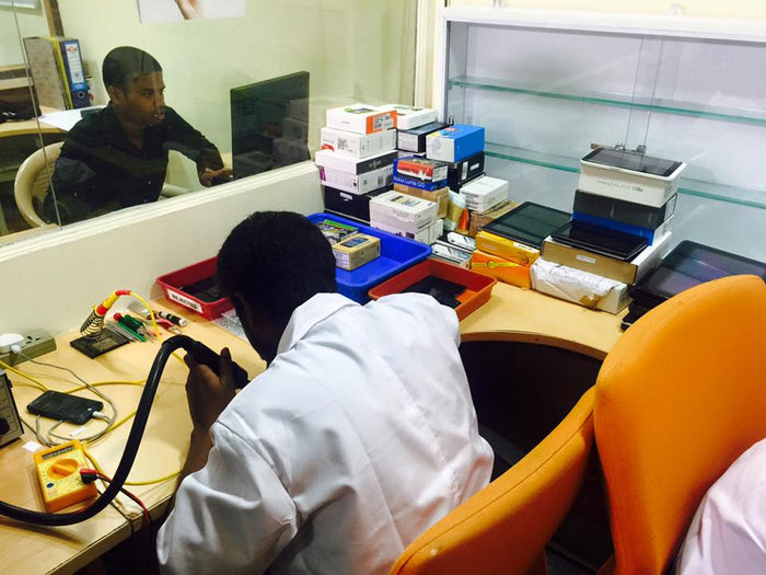 A Budli technician testing a device at the workbench